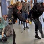 Manchester Airport Brawl: Armed Officer Branded ‘Uncontrolled Bully With a Badge’ in Courtroom Clash.