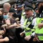 Migrant hotel protests rock the rich postcodes of London: ‘Asylum seekers’ film and laugh at clashes.